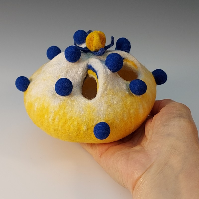 Yellow and white wet-felted vessel with blue bobbles