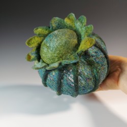 Spherical felt vessel with lacy embroidered panels