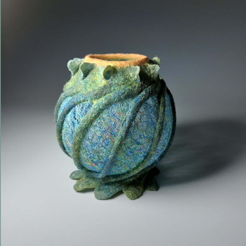 Spherical felt vessel with lacy embroidered panels