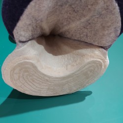 The underside, showing the mirror glued and stitched in place