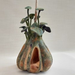 Wet‑felted gourd sculpture in merino wool, silk, and cotton. Decay, fungus, and new growth in fibre art