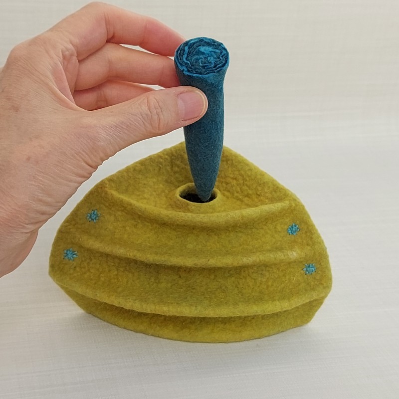Wet-felted quadrant vessel with folds and a stopper